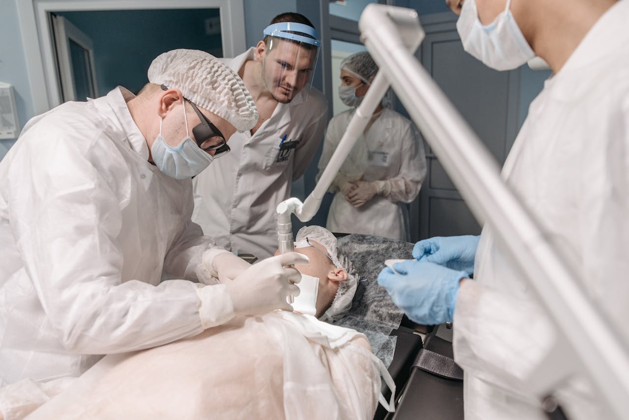 Healthcare professionals in an operating room conducting a laser treatment procedure.